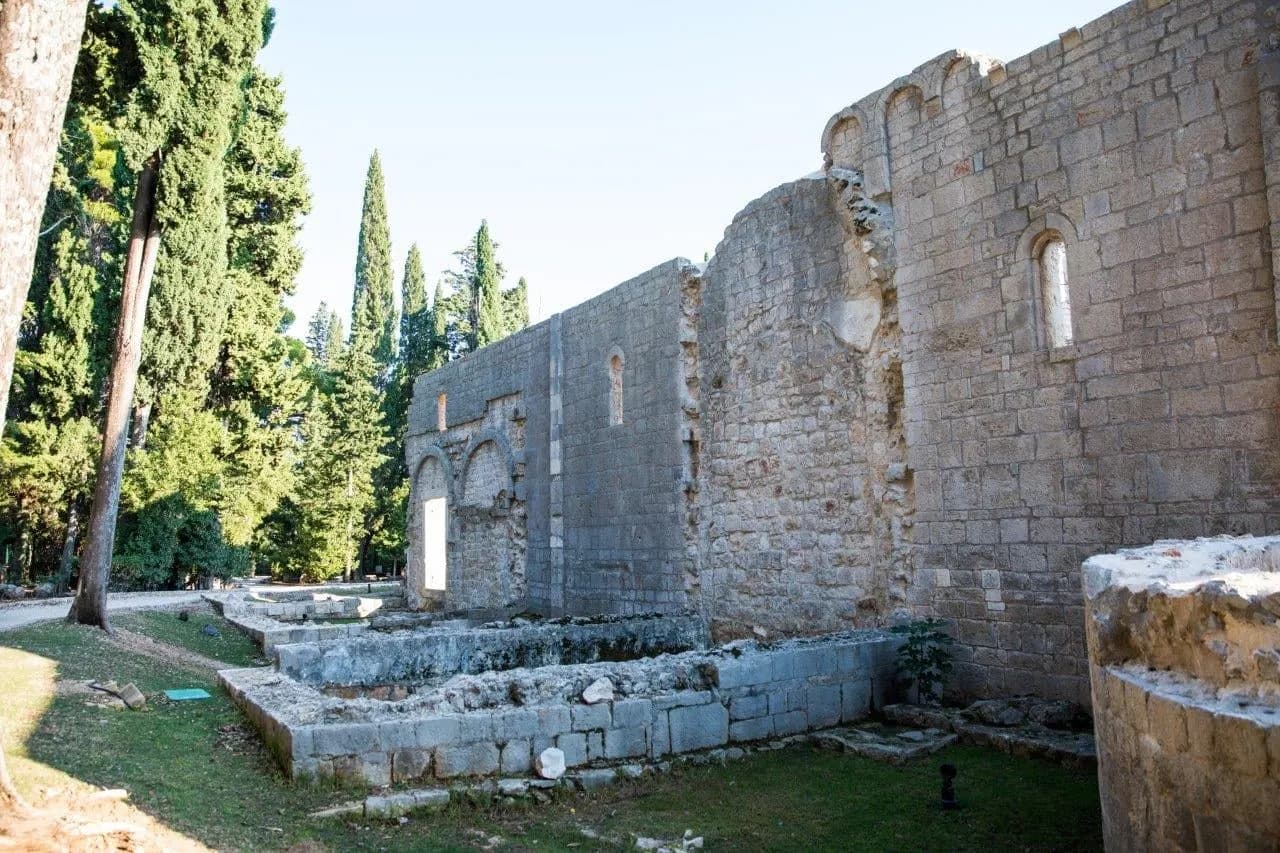 Stone ruins of the old monastery among cypress trees on Lokrum