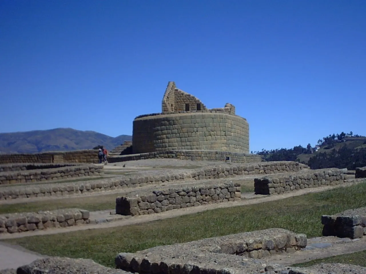 The curved stone Temple of the Sun at Ingapirca under a blue sky