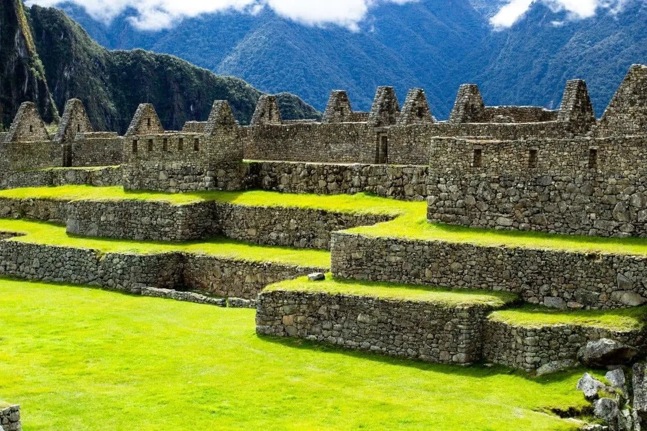 Grassy terraces and Inca stone buildings at Machu Picchu