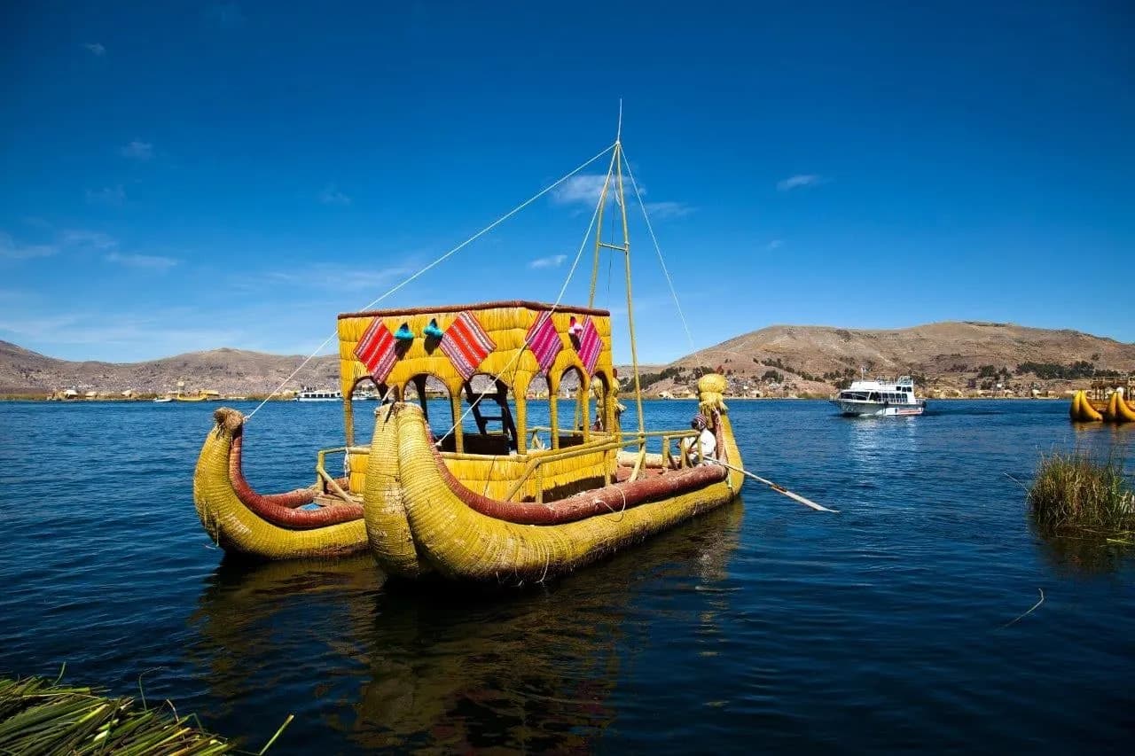 A traditional reed boat on the blue water of Lake Titicaca