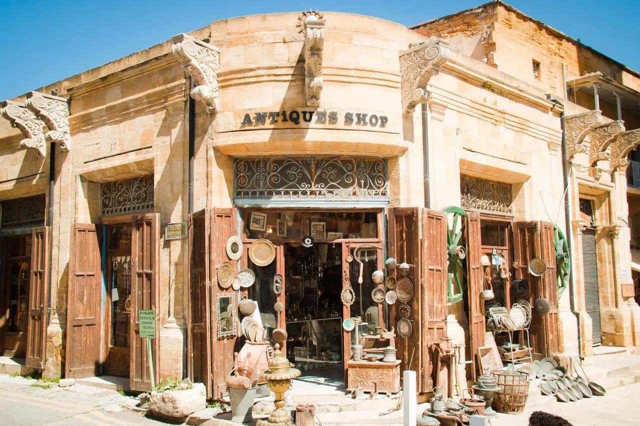 A sandstone antiques shop with wares set out on the street
