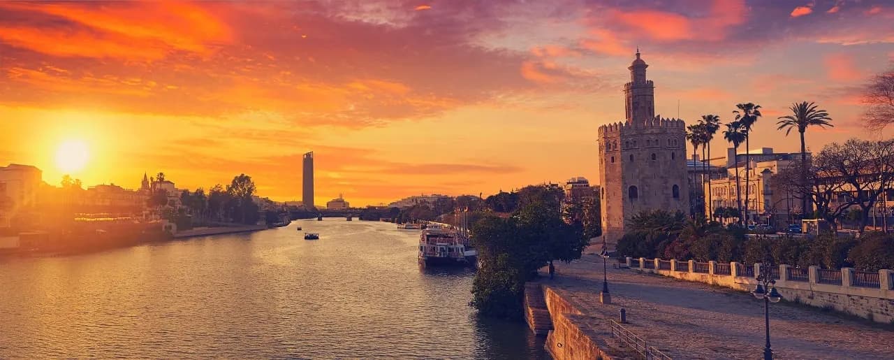 The Torre del Oro beside the Guadalquivir river in Seville at sunset