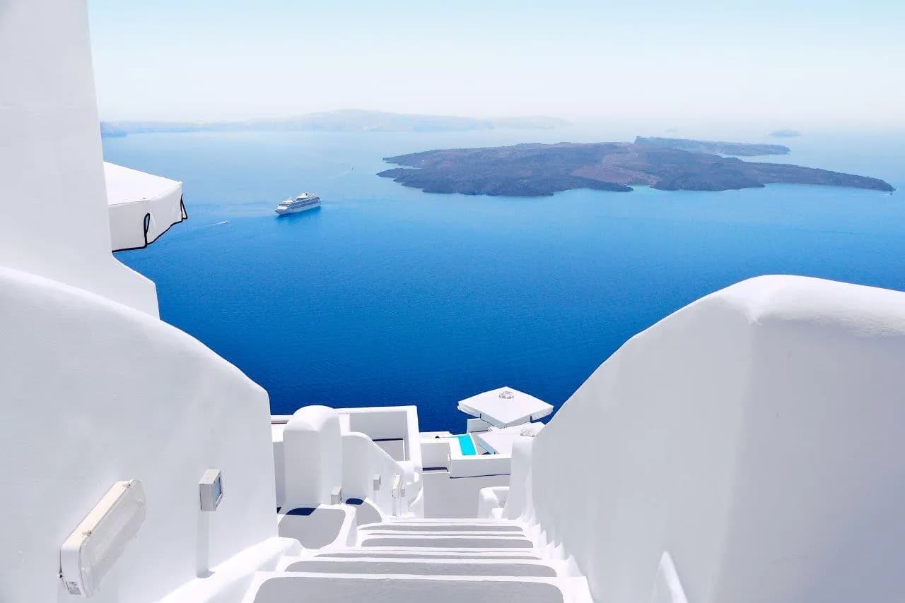 White steps leading down towards the Santorini caldera