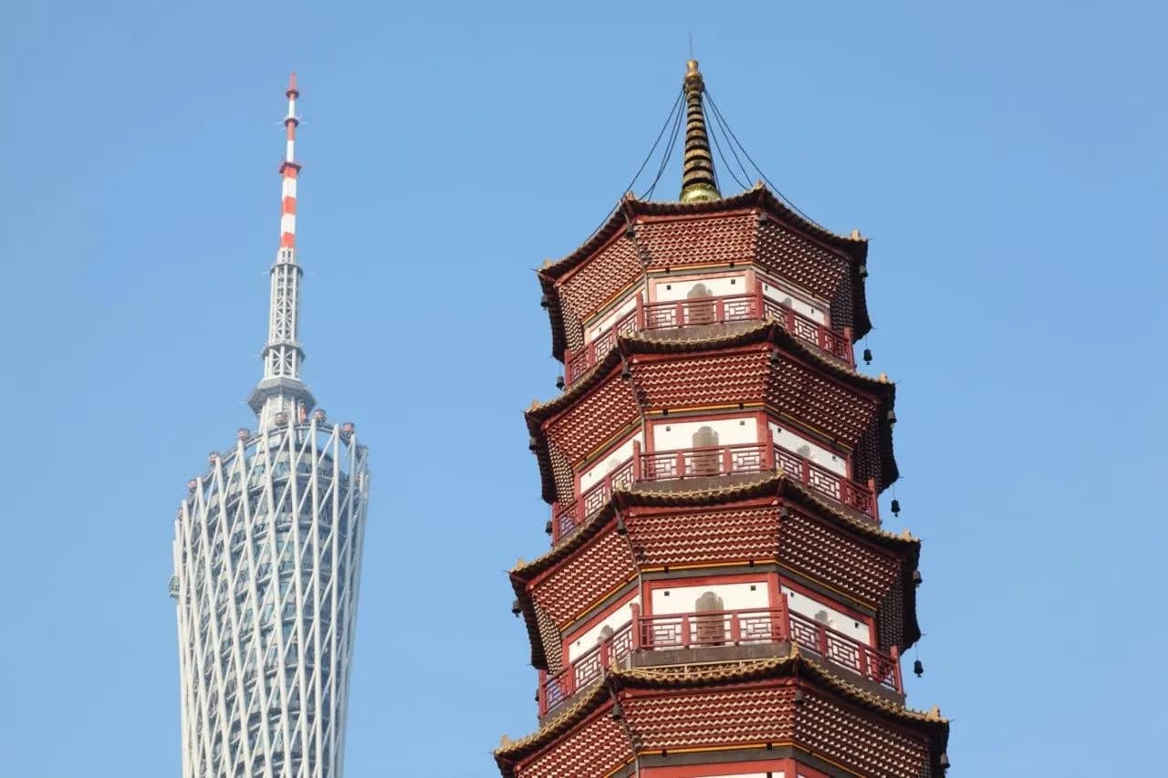 Canton Tower rising beside a traditional red pagoda