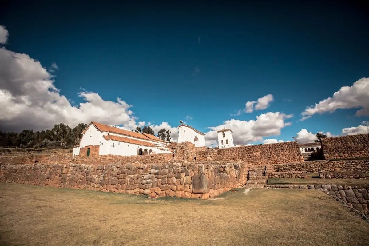 Inca stone walls and a white colonial church at Chinchero