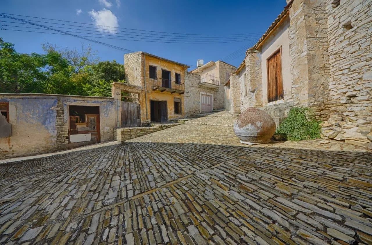 A cobbled lane between old stone houses in a hill village
