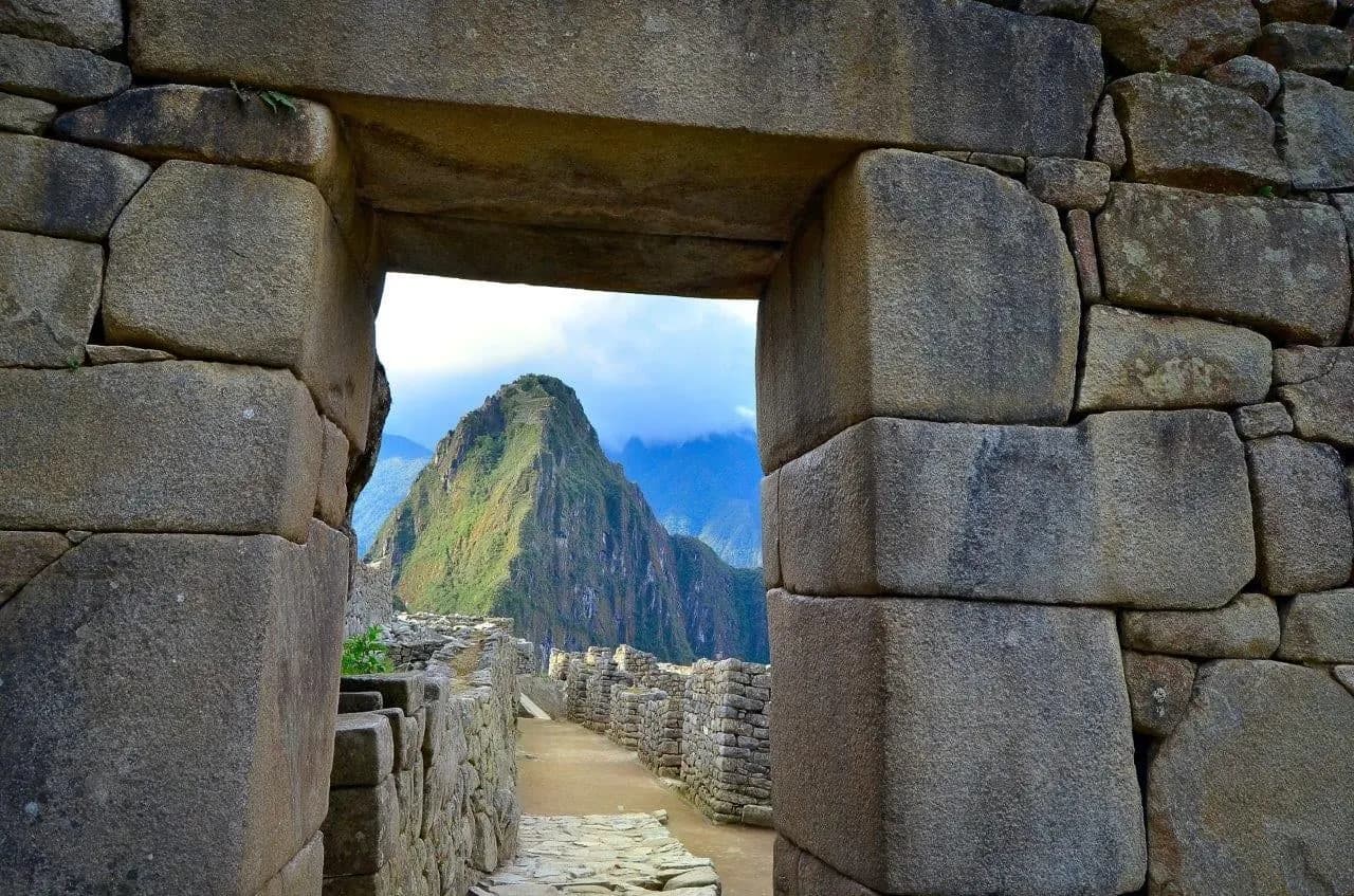 Huayna Picchu seen through a stone Inca doorway at Machu Picchu