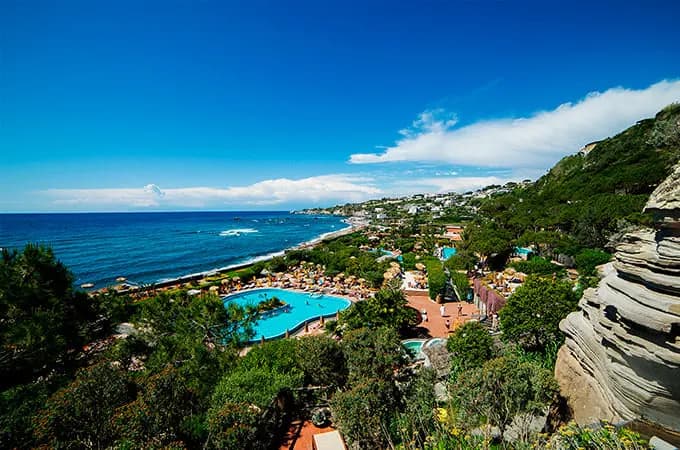 Thermal pools set in green terraced gardens above a long beach on Ischia