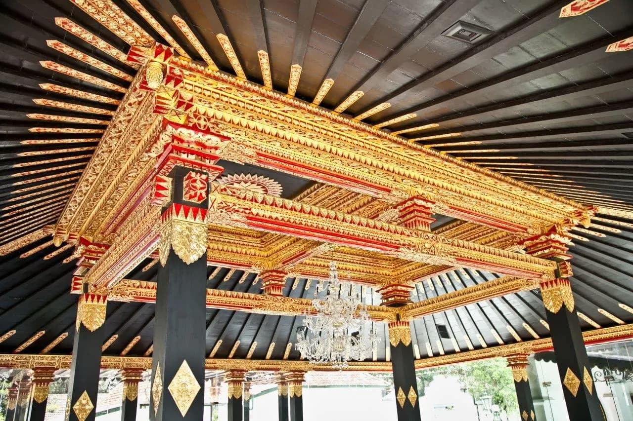 The gilded red and gold ceiling of a pavilion at the Sultan's Palace in Yogyakarta