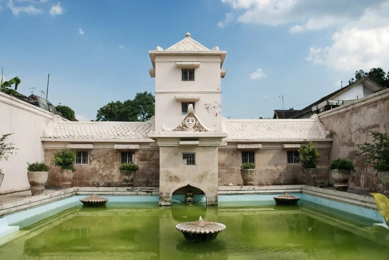 A green bathing pool and white tower at Taman Sari, the Water Palace in Yogyakarta