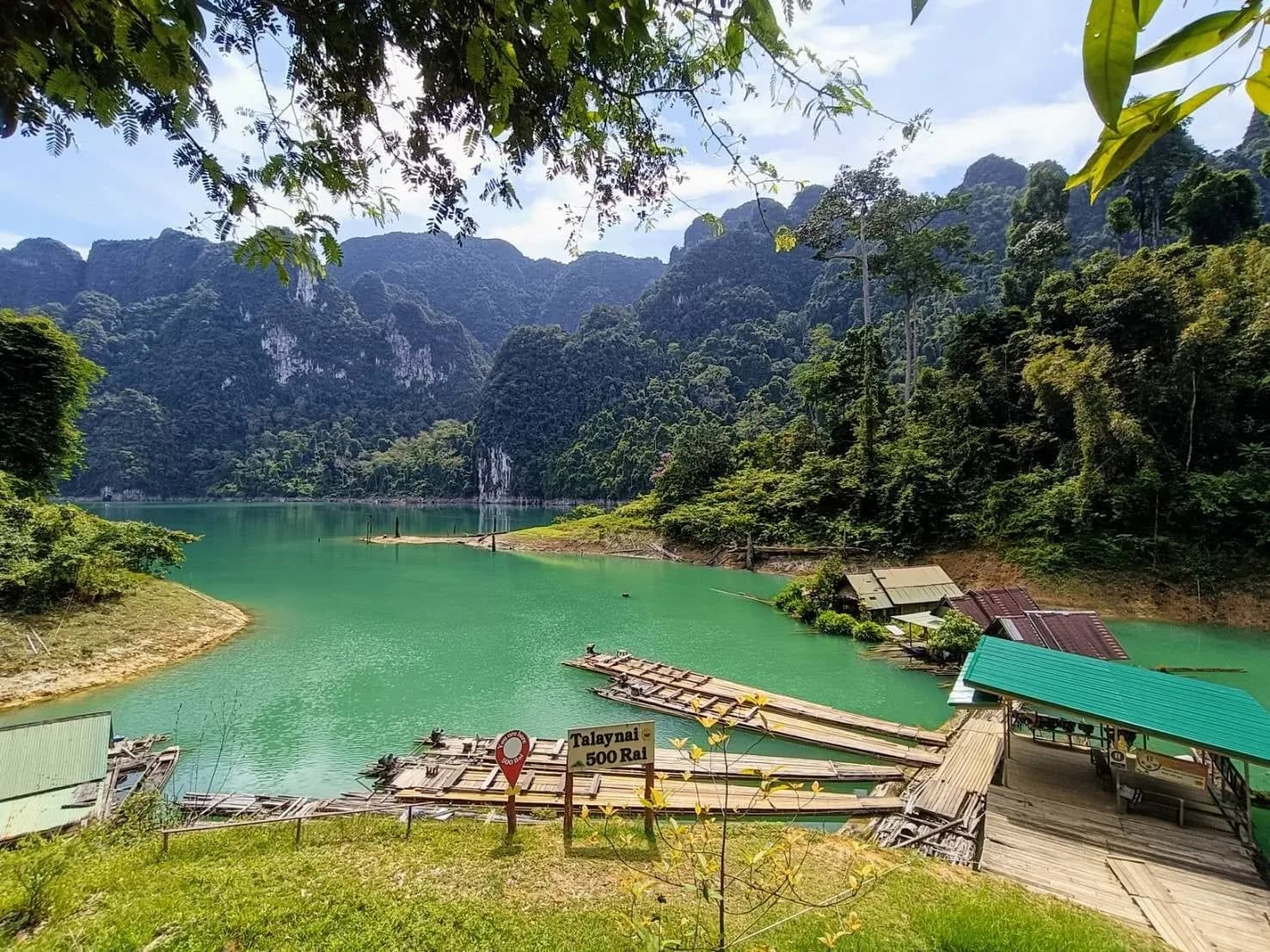 Bamboo rafts and floating huts on an emerald inlet of Cheow Lan Lake