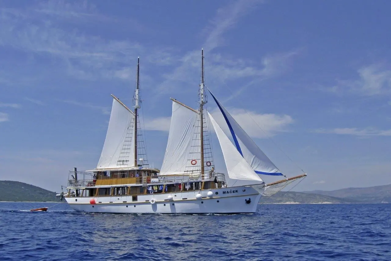 A two-masted cruise boat under full sail on the Adriatic