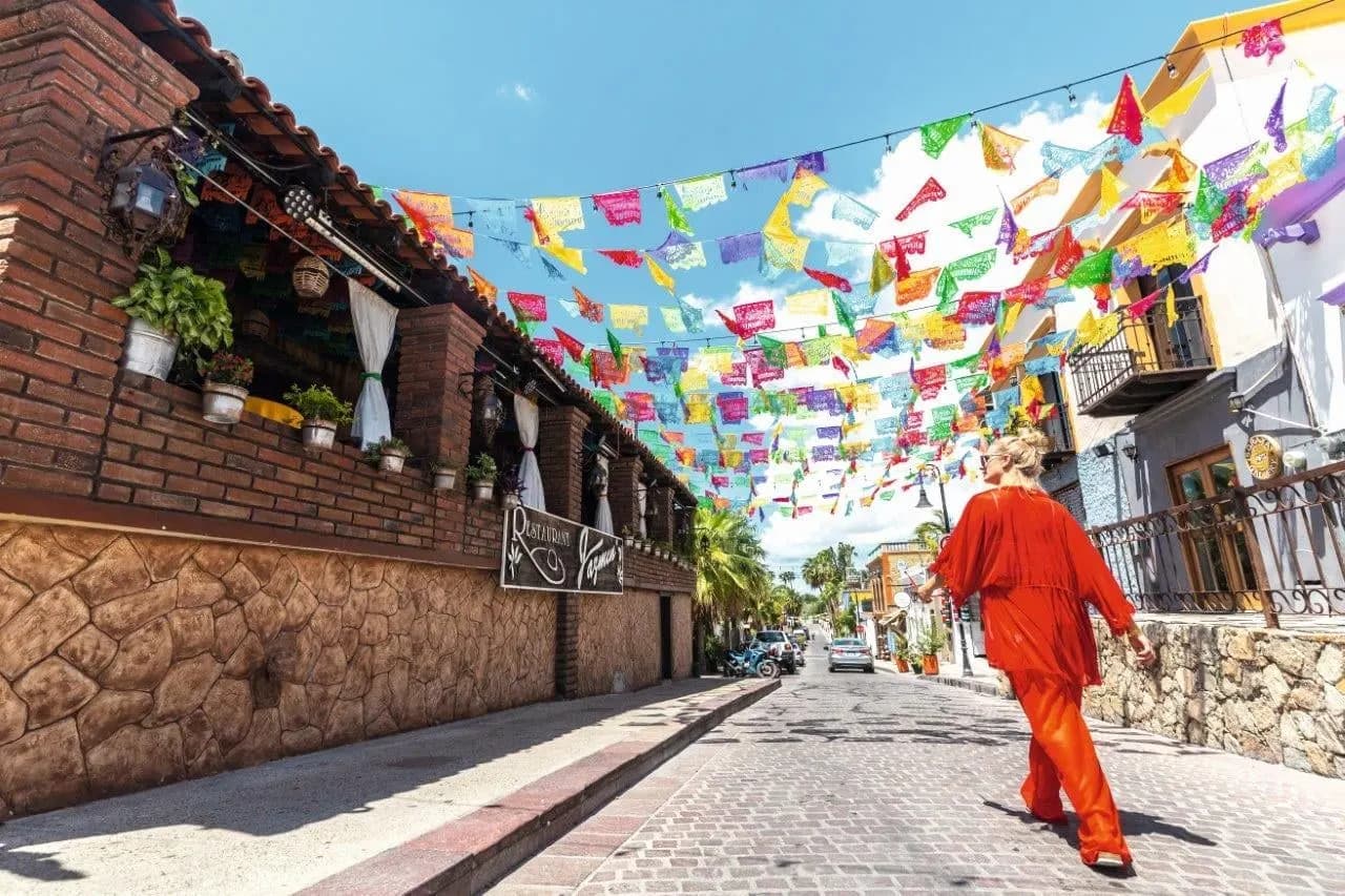 Strings of colourful paper flags over a cobbled street