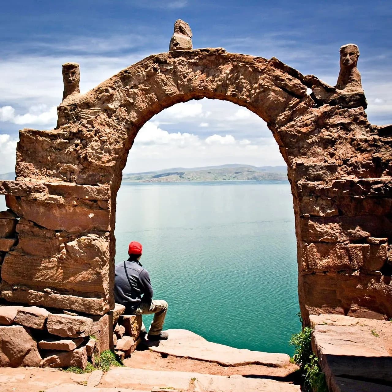 A stone archway on Taquile Island framing the blue water of Lake Titicaca