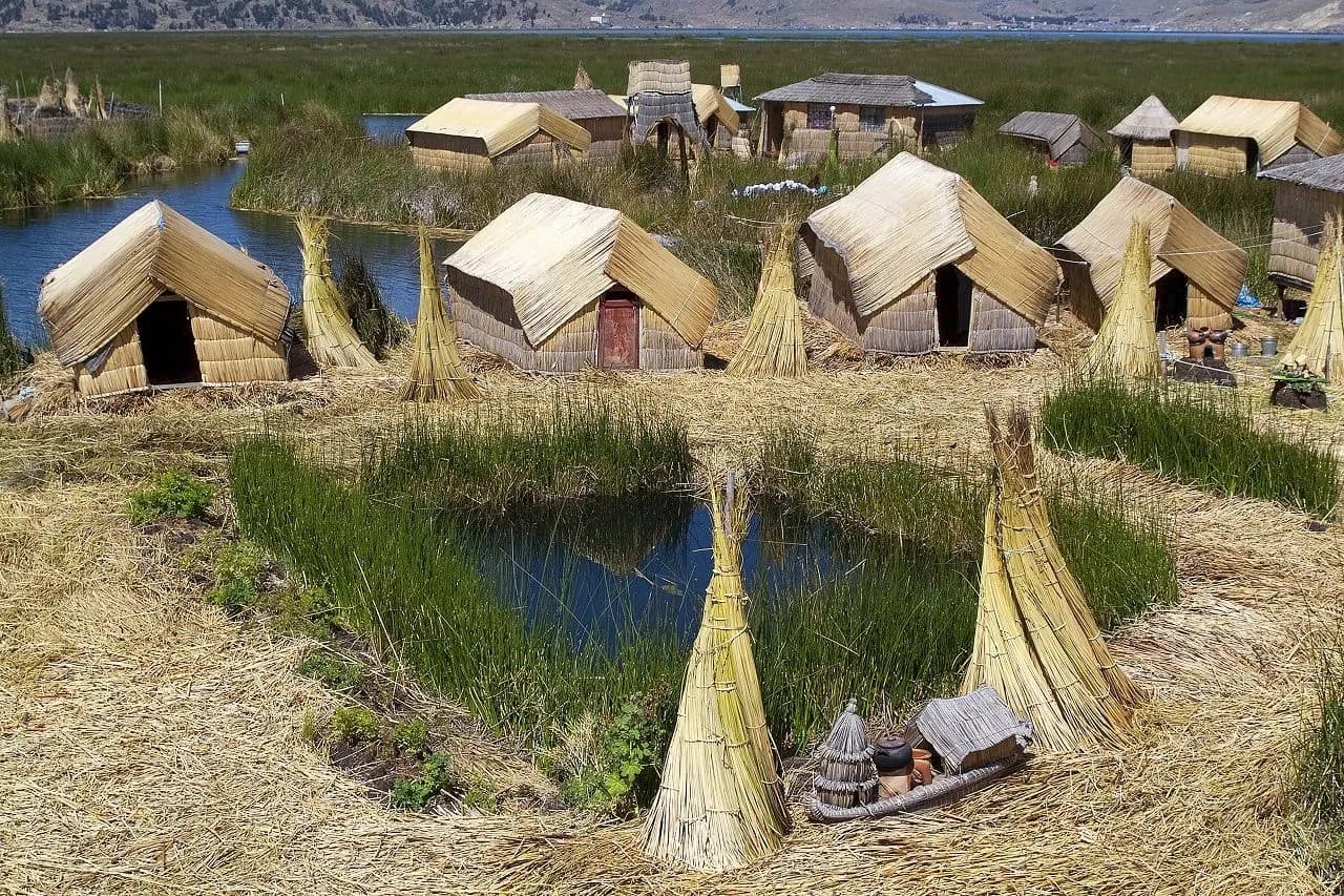 Reed huts and bundled reeds on one of the Uros floating islands