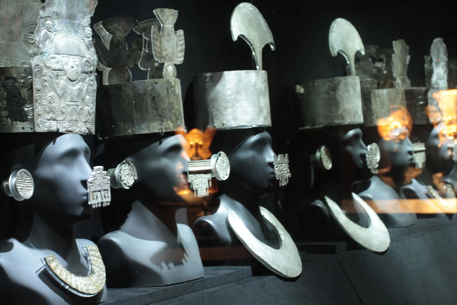 Museum busts wearing ancient silver headdresses and collars