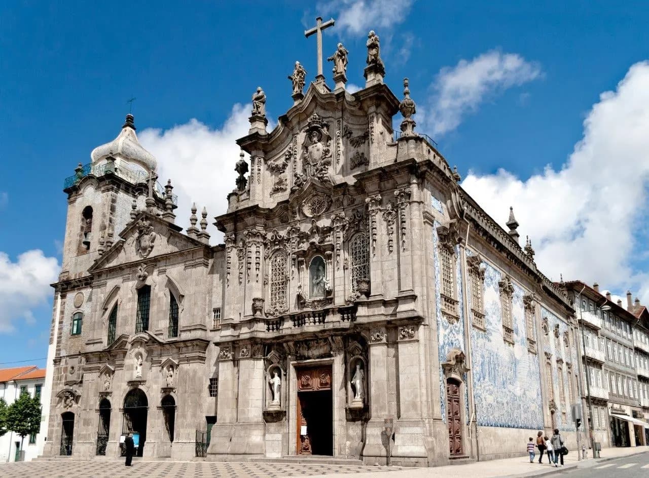 The baroque Carmo church in Porto with blue and white tiles on its side wall