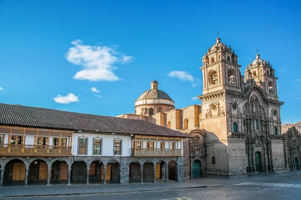 A baroque church and arcaded colonial buildings on Cusco's Plaza de Armas