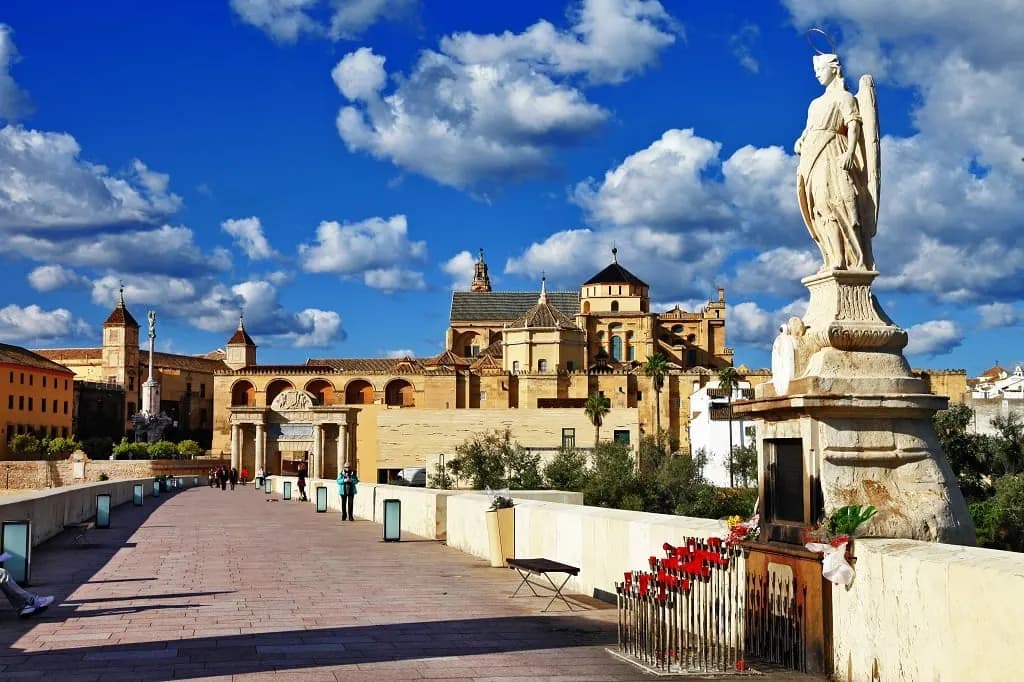 A statue on the Roman bridge in Córdoba, looking towards the Great Mosque