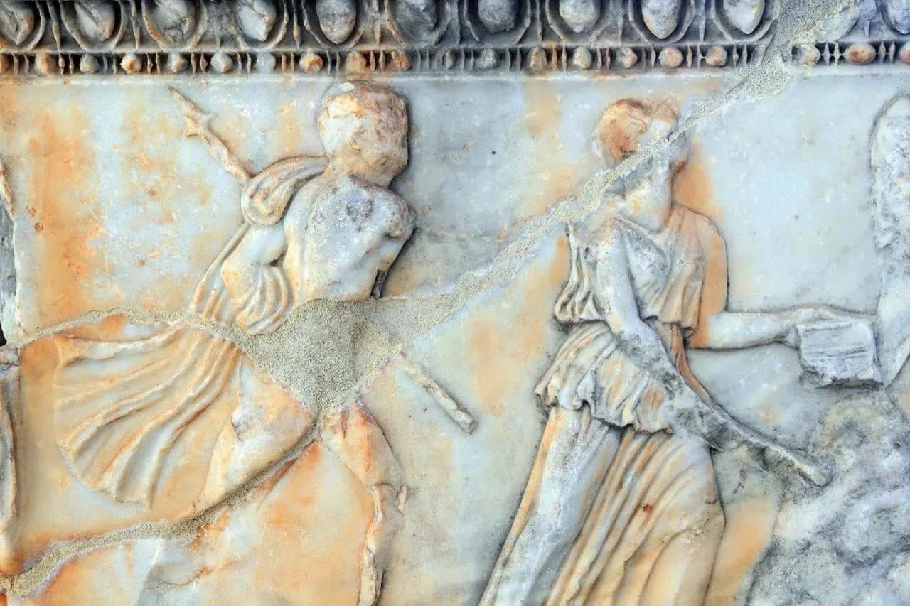 A carved marble relief of figures from ancient Greece