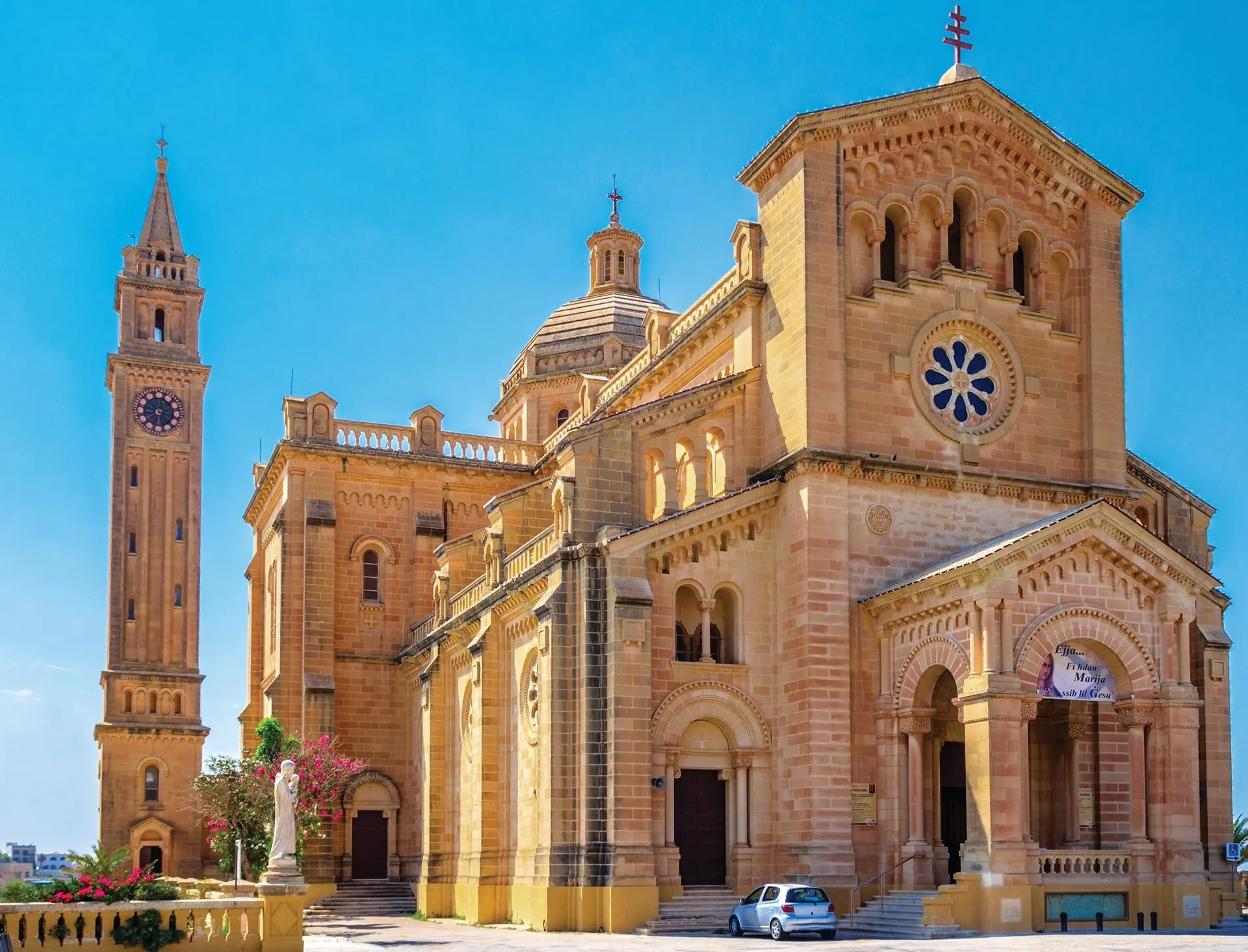 The honey-coloured stone basilica of Ta' Pinu and its bell tower on Gozo