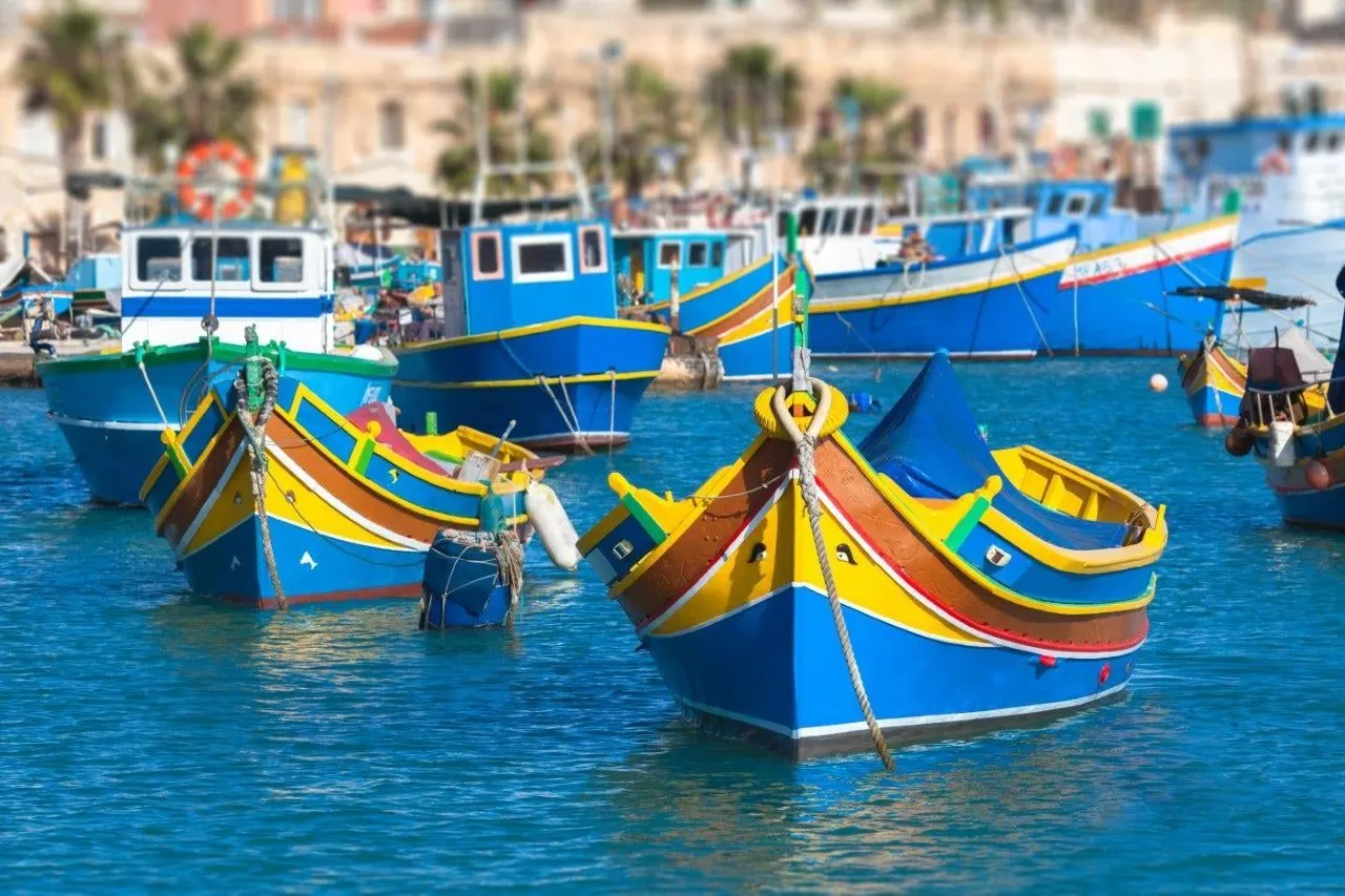 Painted luzzu fishing boats moored in a Maltese harbour