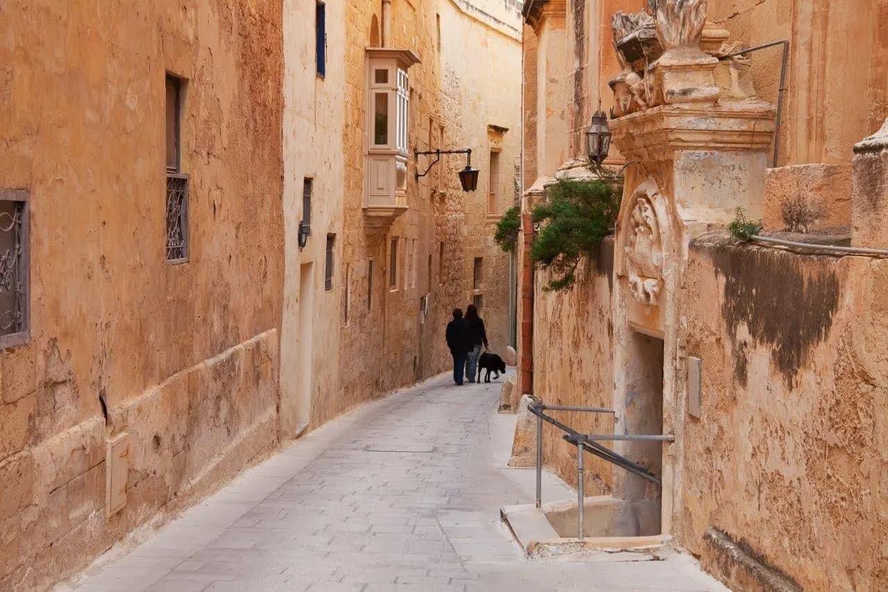 A narrow honey-coloured stone lane in Mdina