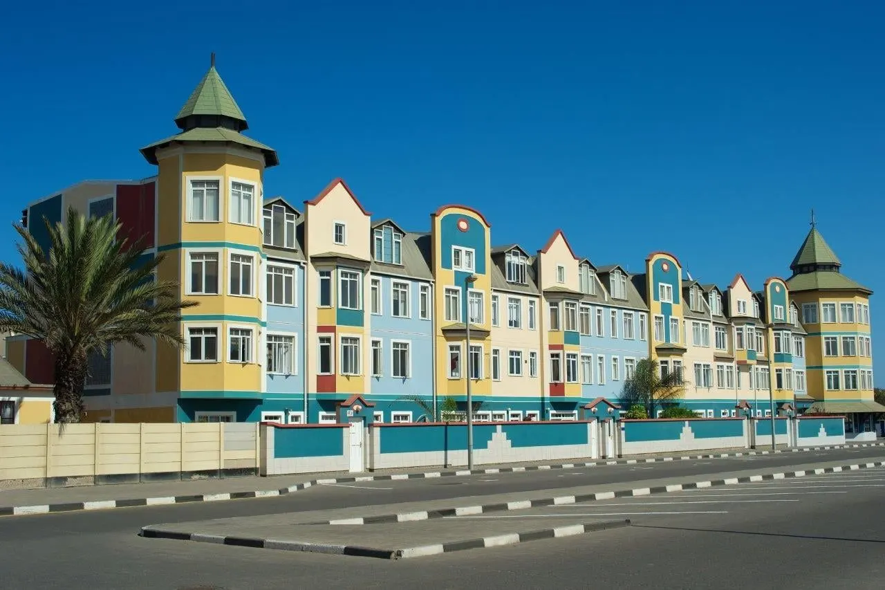 A row of pastel German colonial buildings with turrets in Swakopmund