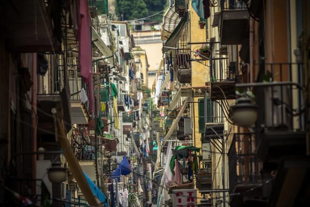 A narrow lane in the old centre of Naples lined with balconies