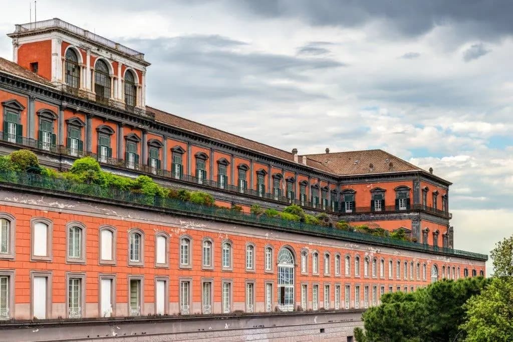 The red façade and roof garden of the Royal Palace of Naples