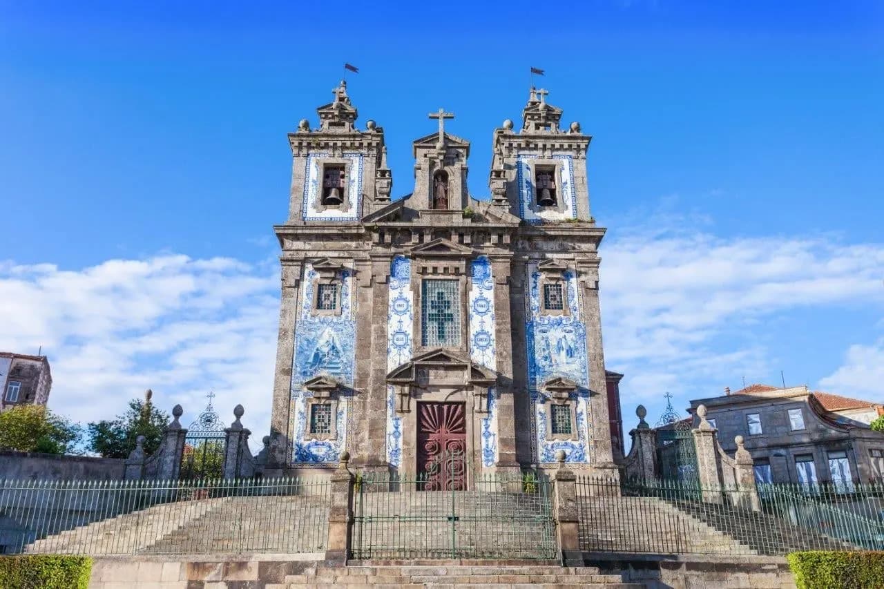 The blue tiled facade and twin towers of Santo Ildefonso church in Porto