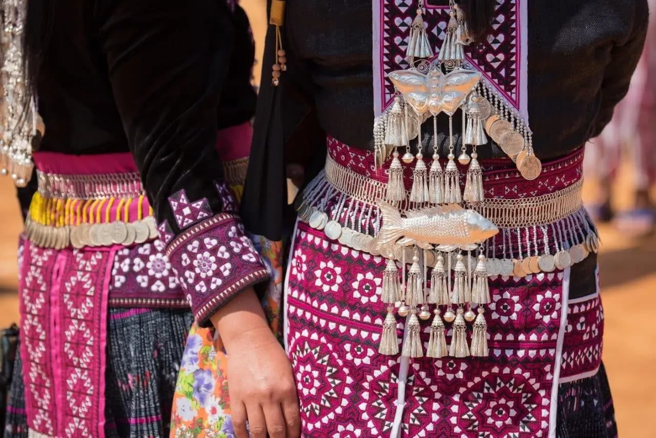 Embroidered hill tribe dress hung with silver ornaments