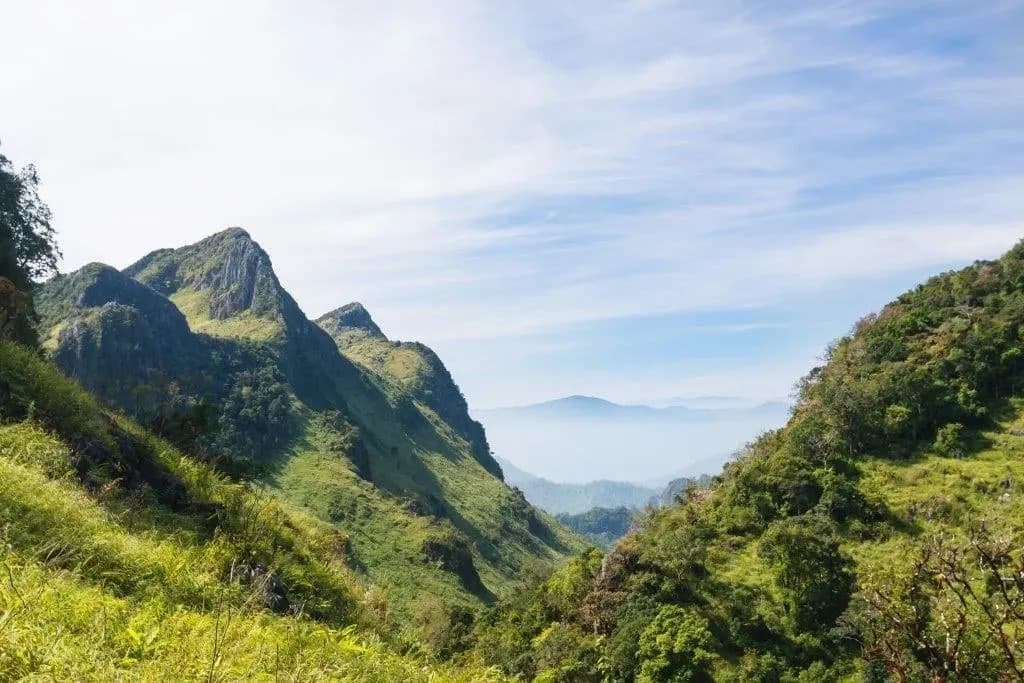 Green mountain ridges fading into haze in northern Thailand