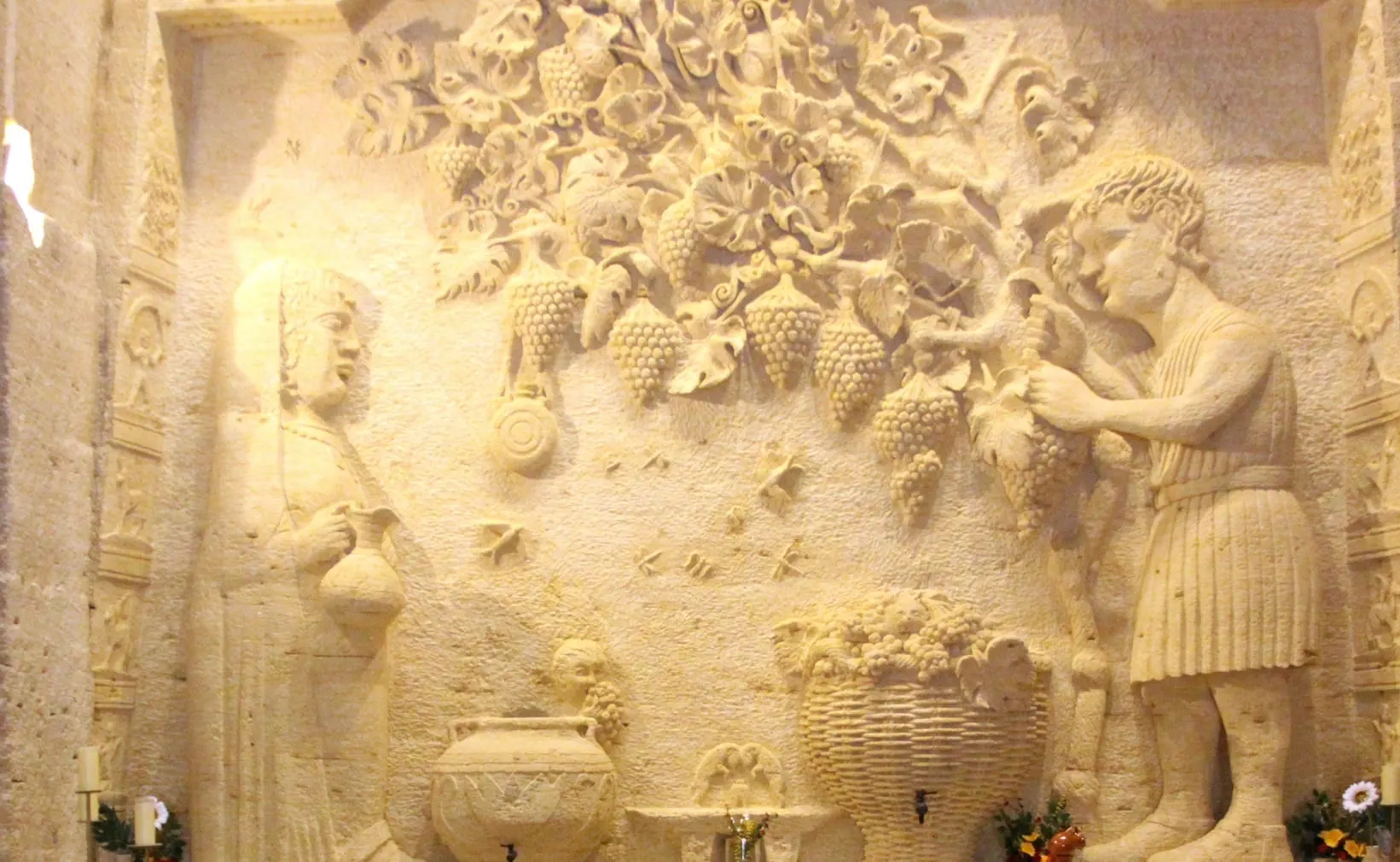A grape harvest scene carved in relief into the quarry wall