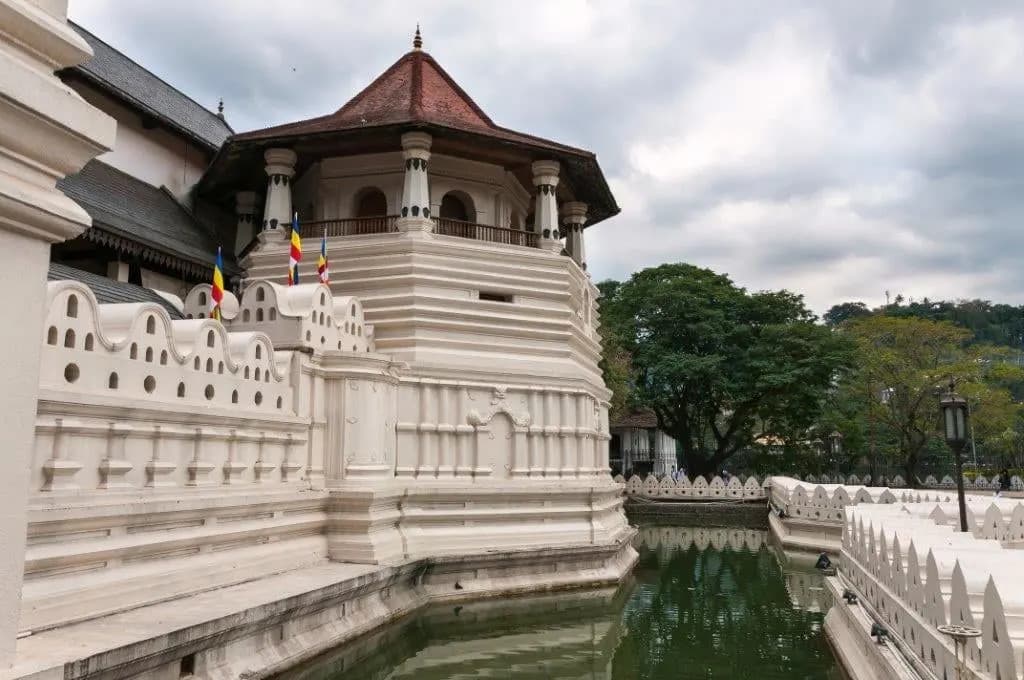 The white octagonal pavilion of the Temple of the Tooth above its moat