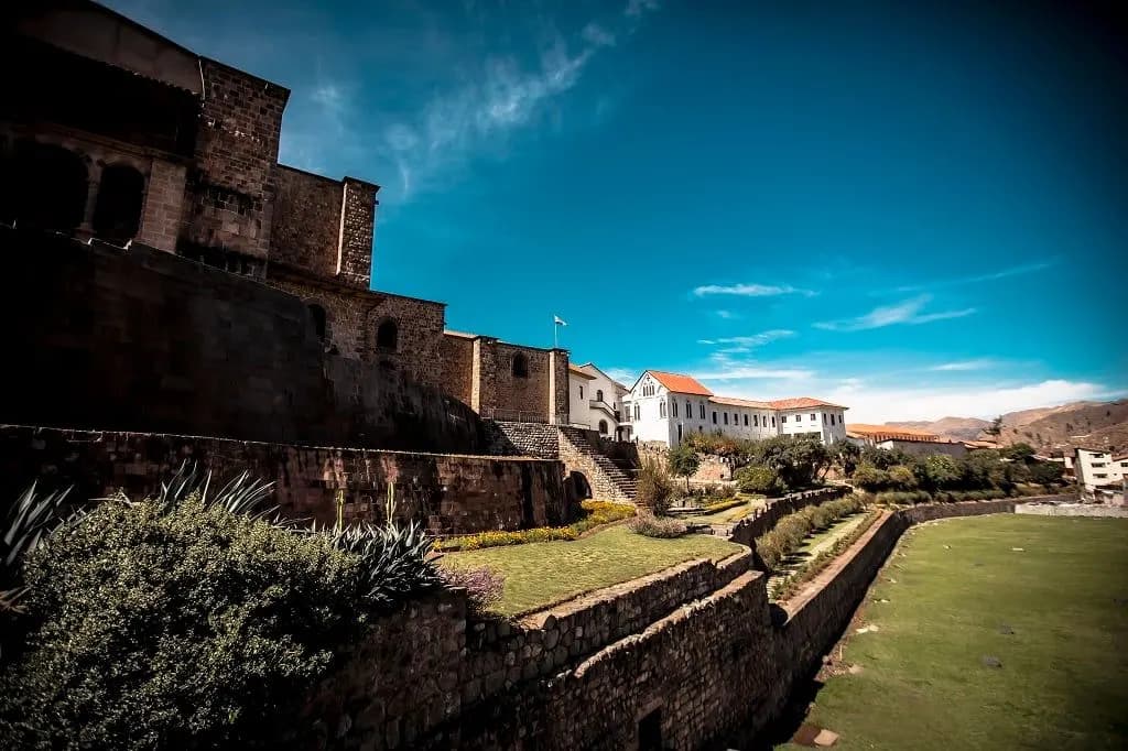 The stone walls of Coricancha above its terraced gardens in Cusco