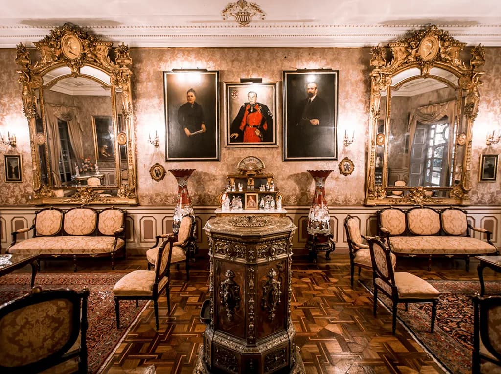 A colonial drawing room with gilded mirrors and portraits in Lima
