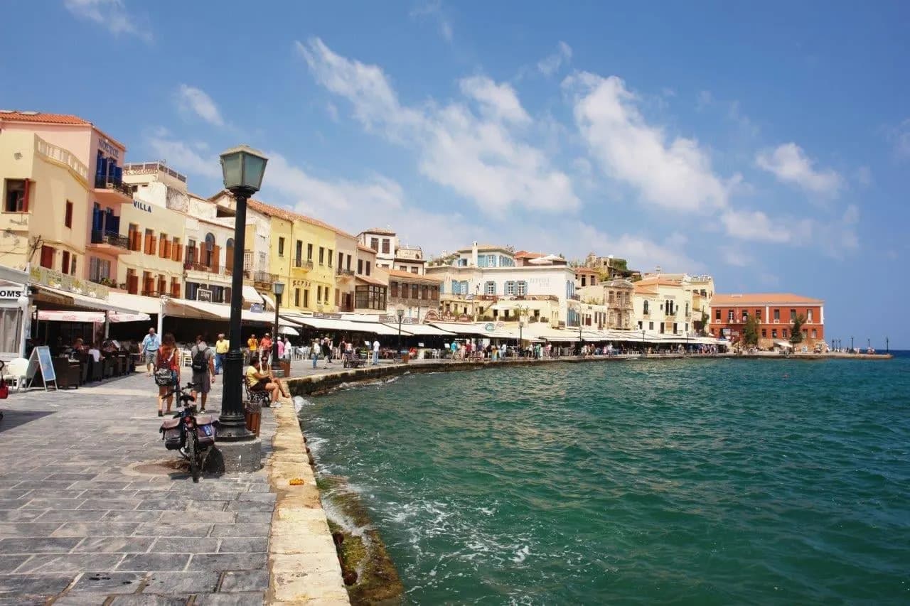 The curving harbour front of Chania with its pastel houses and cafes