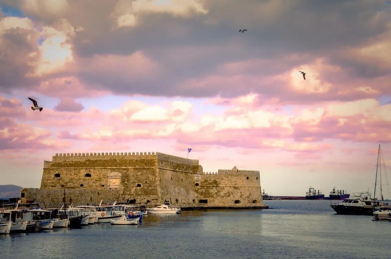 The Venetian fortress at the entrance to Heraklion harbour under a pink sky