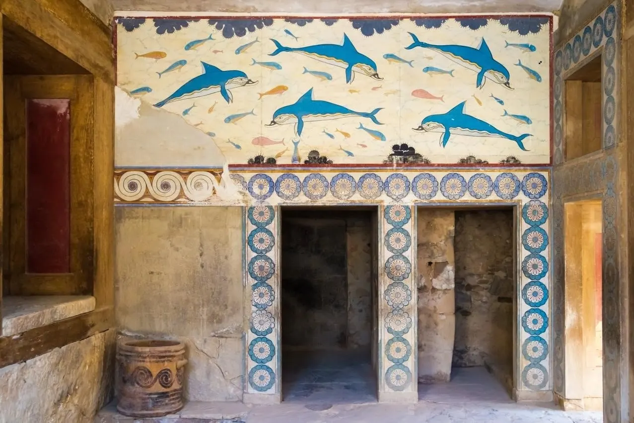 The blue dolphin fresco above a painted doorway at the Palace of Knossos