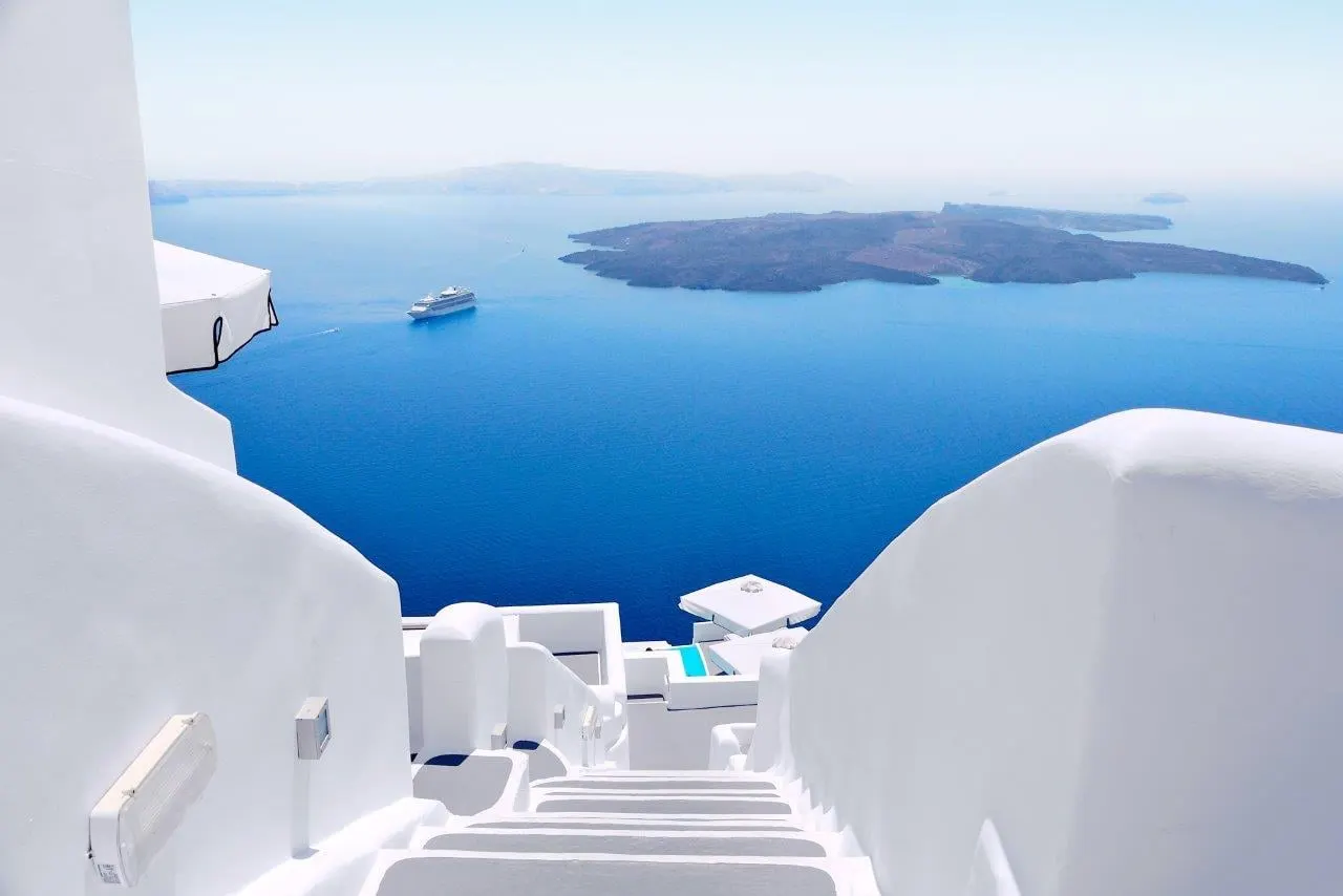 White steps and walls looking over the Santorini caldera to the sea
