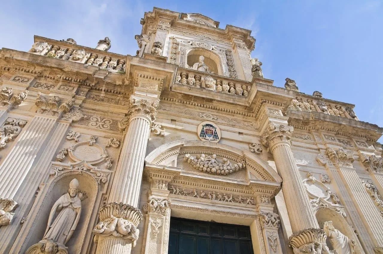 The carved baroque stone front of a church in Lecce