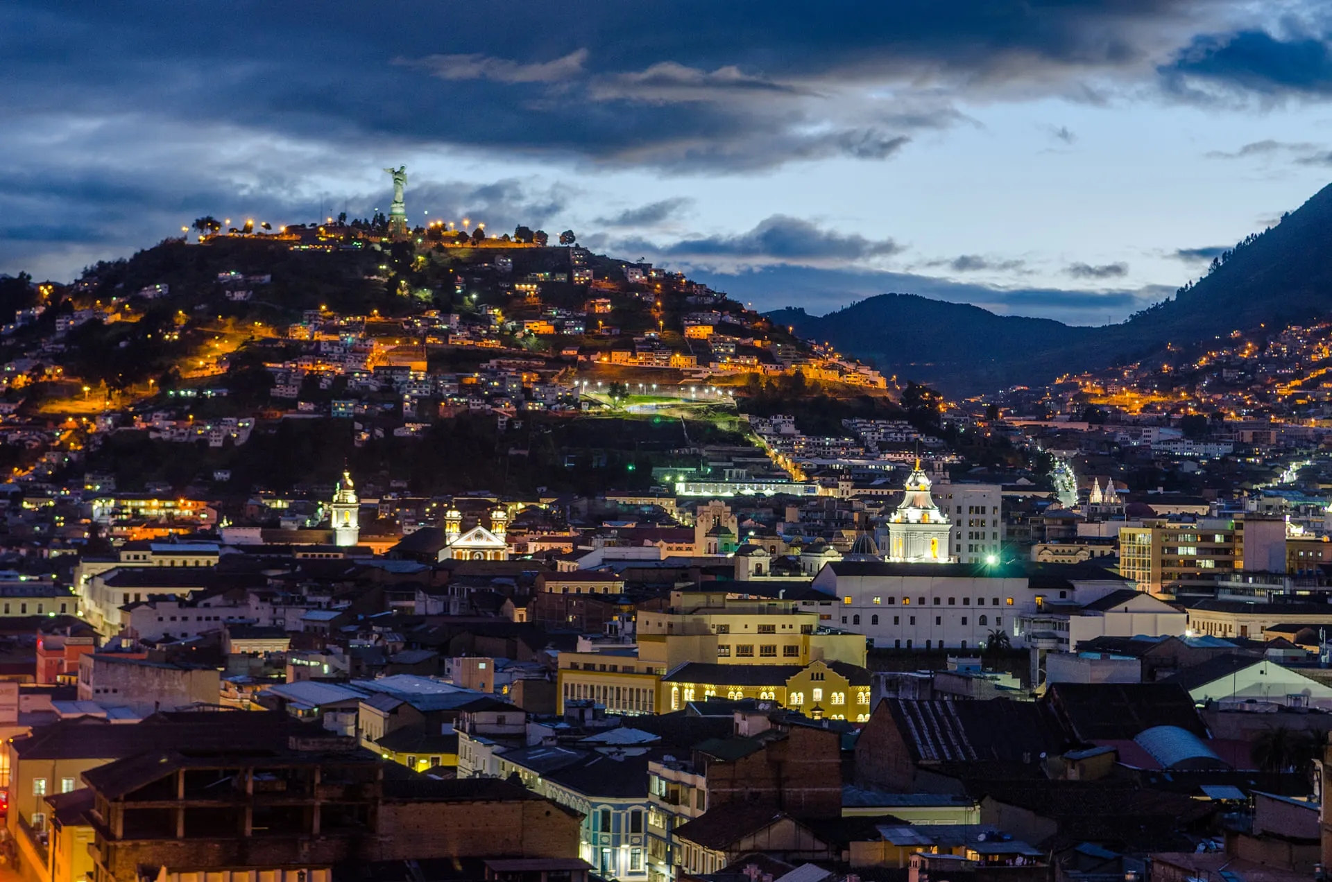 Quito's lights spreading over the hills at dusk