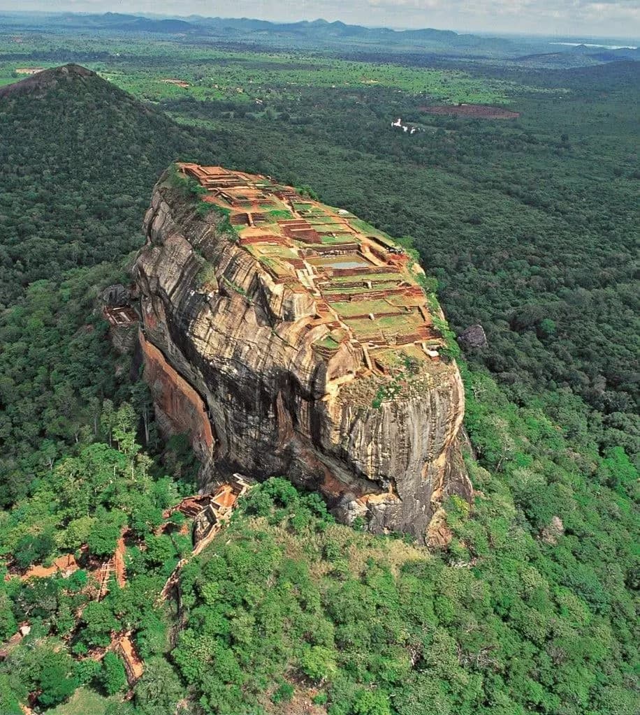 Sigiriya Rock rising from green forest, seen from the air