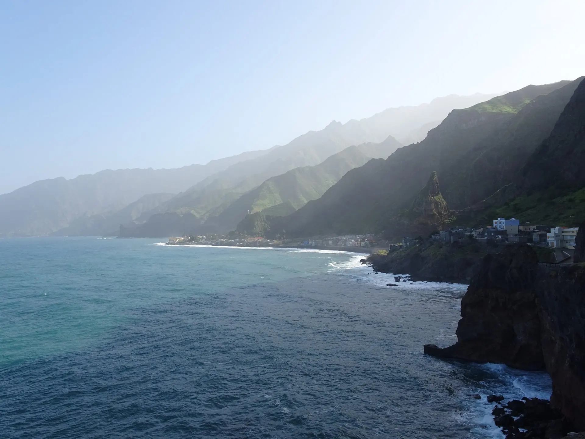 Green mountains dropping into the Atlantic along a rocky coast