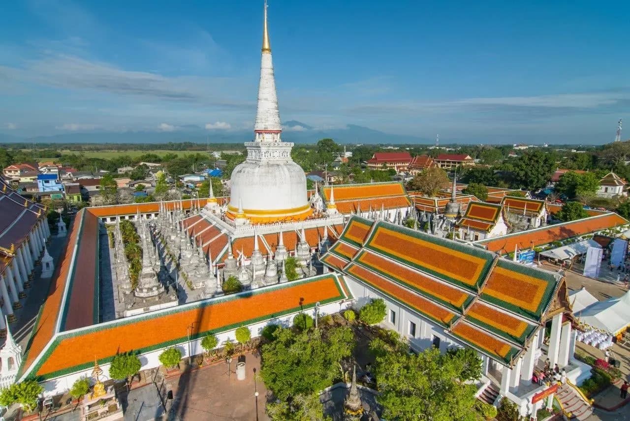 The white chedi and orange roofs of Wat Phra Mahathat in Nakhon Si Thammarat