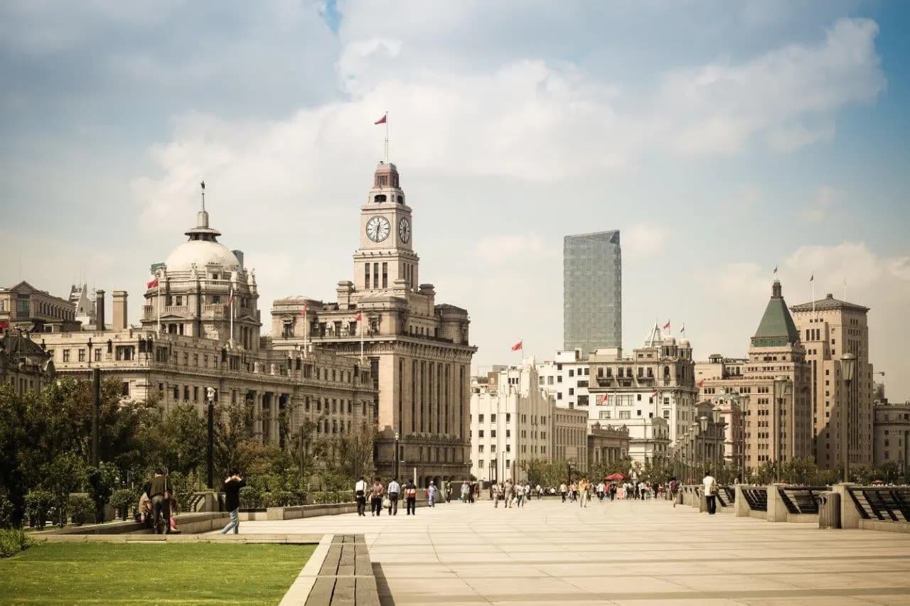 Historic stone buildings and the clock tower along the Bund