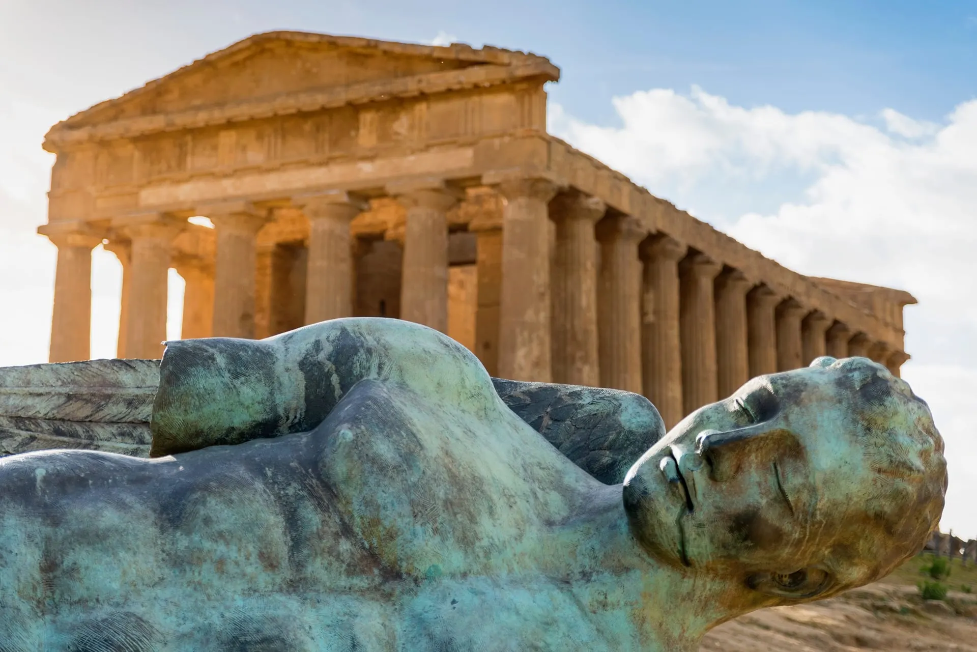 The Temple of Concordia in the Valley of the Temples, with a fallen bronze figure in front