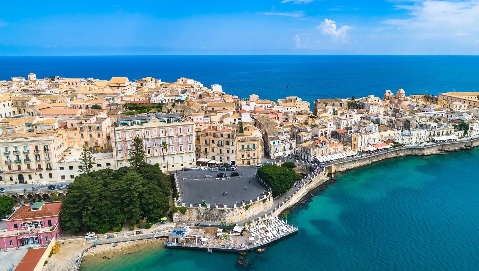 The island of Ortigia in Siracusa seen from above, ringed by turquoise sea