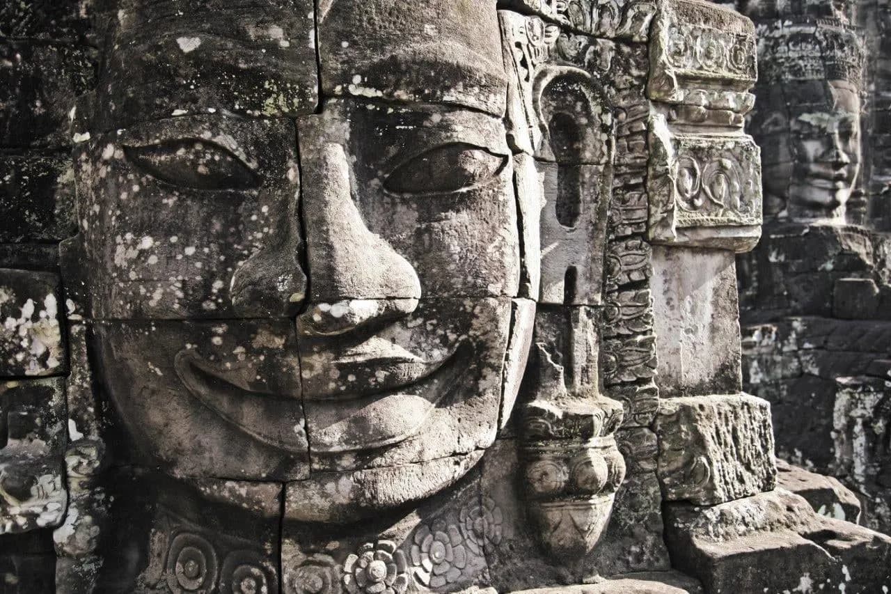 Close view of smiling carved faces on the towers of the Bayon